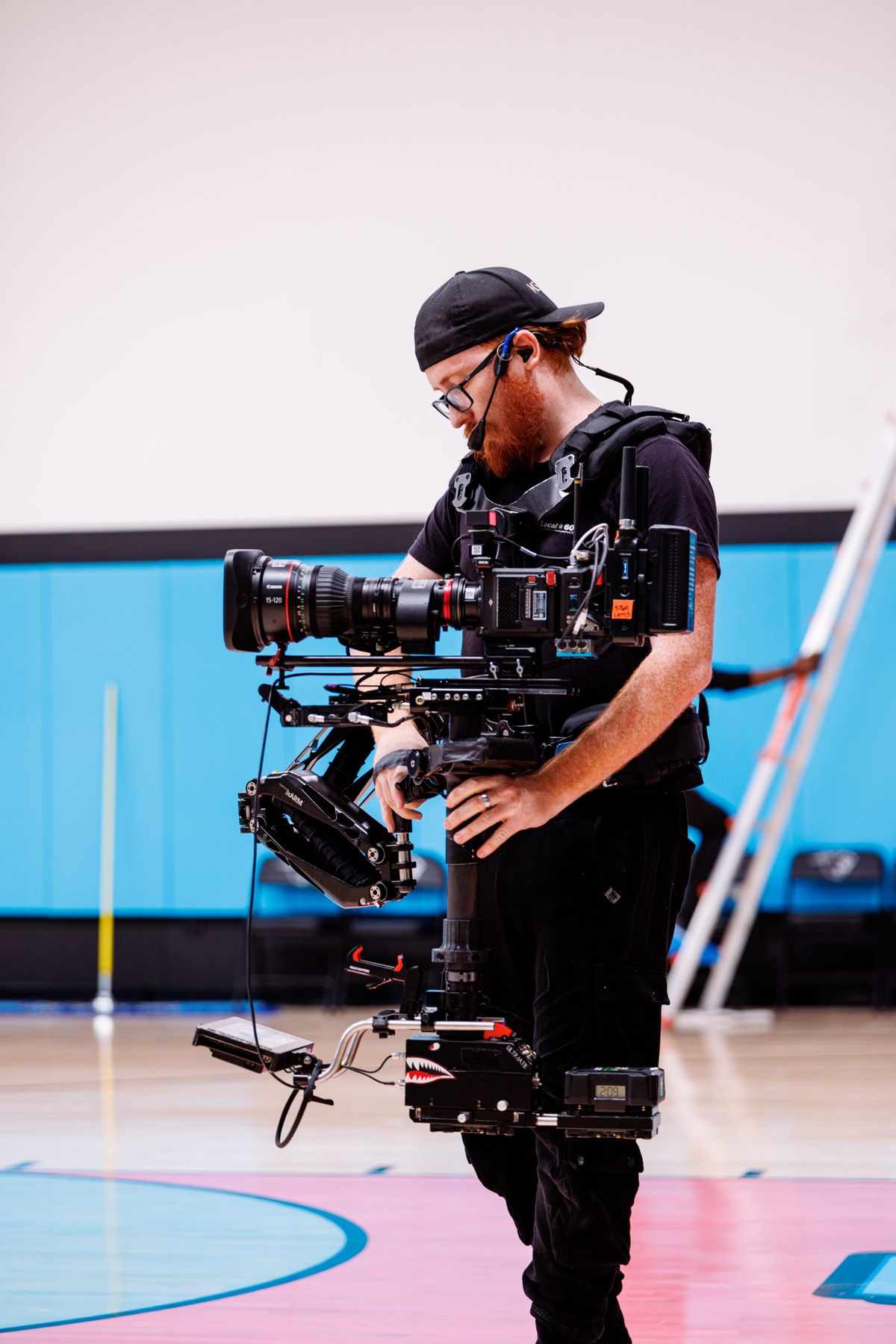 Camera operator with a RED Komodo-X on the court at Beast Arena, LED wall behind