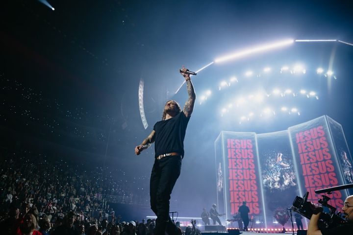 Vertical social cut — Brandon Lake at the lip of the stage, arm raised